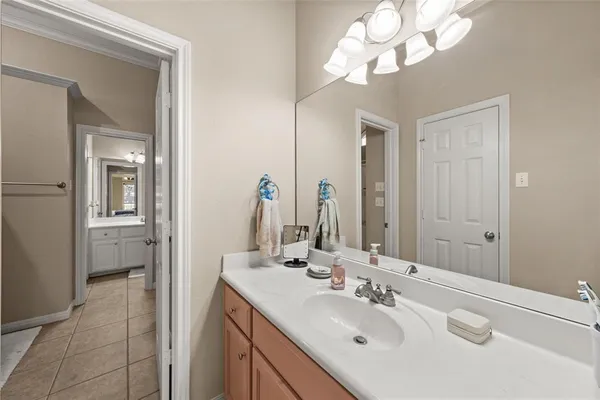 a bathroom with a sink vanity and a mirror