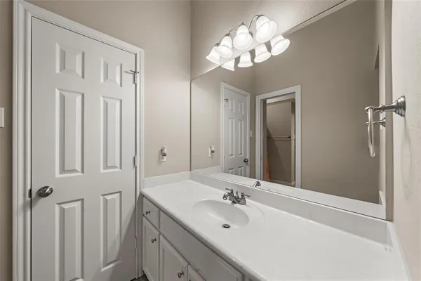 a bathroom with a sink vanity and a mirror