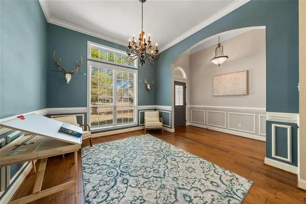 a living room with furniture and a chandelier