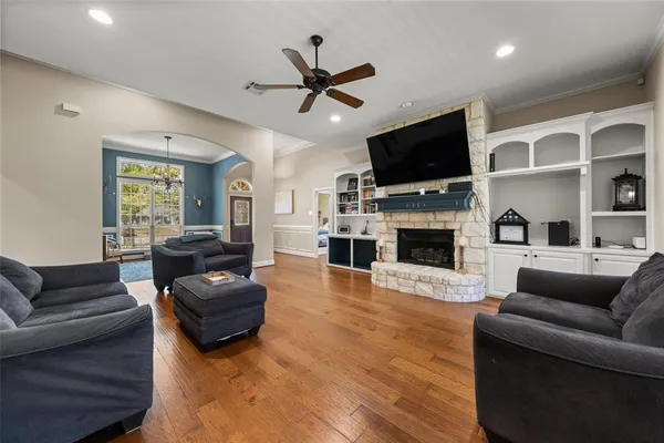 a living room with furniture a flat screen tv and a fireplace