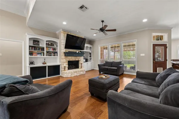 a living room with furniture a flat screen tv and a fireplace