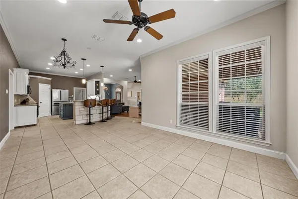 a view of a livingroom with furniture and chandelier fan