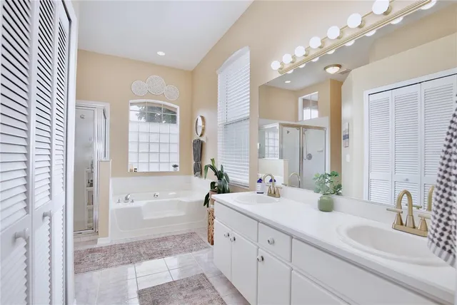 a bathroom with a double vanity sink mirror and shower