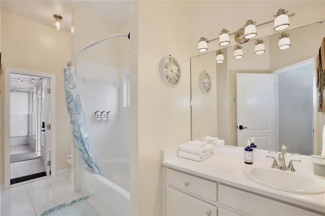 a living room with patio furniture and a potted plant