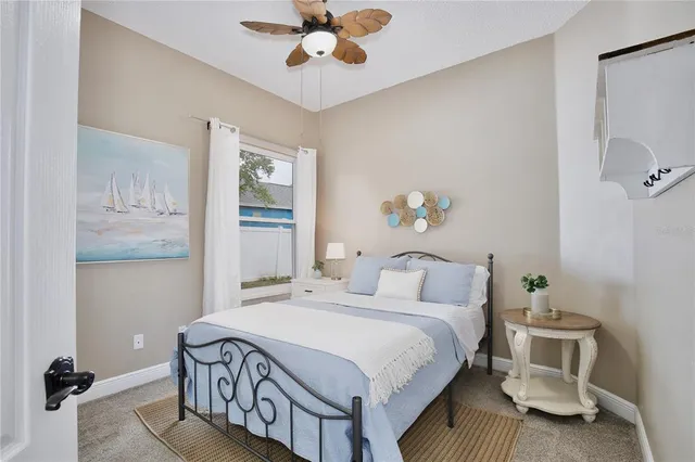 a living room with patio furniture and a floor to ceiling window