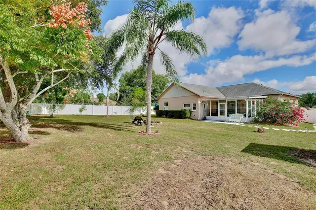 an aerial view of a house with swimming pool and green space