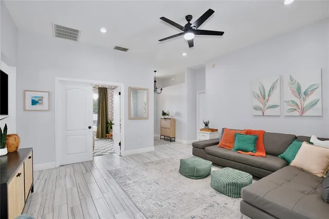 a living room with furniture and a wooden floor