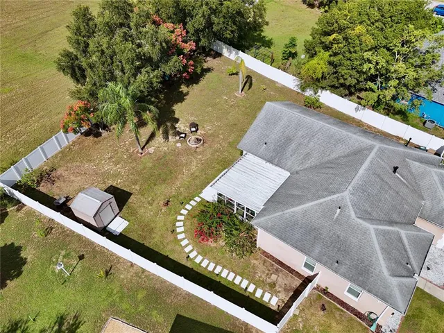 an aerial view of residential houses with outdoor space and river