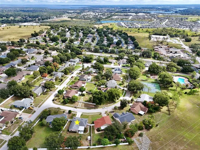 an aerial view of a house with a garden and trees