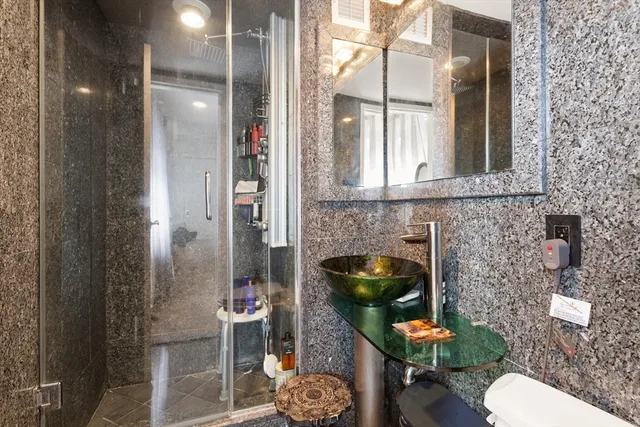 a bathroom with a toilet and a shower