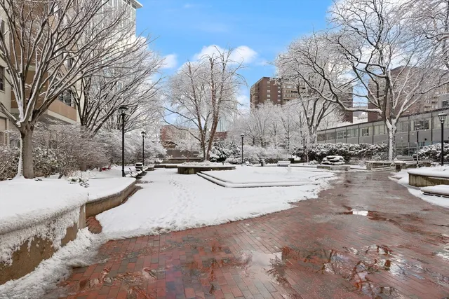 a view of road with snow on the roadside