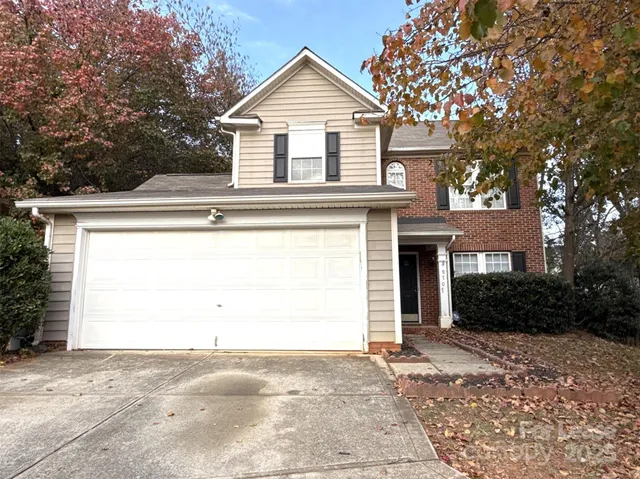 a view of a house with a yard and garage