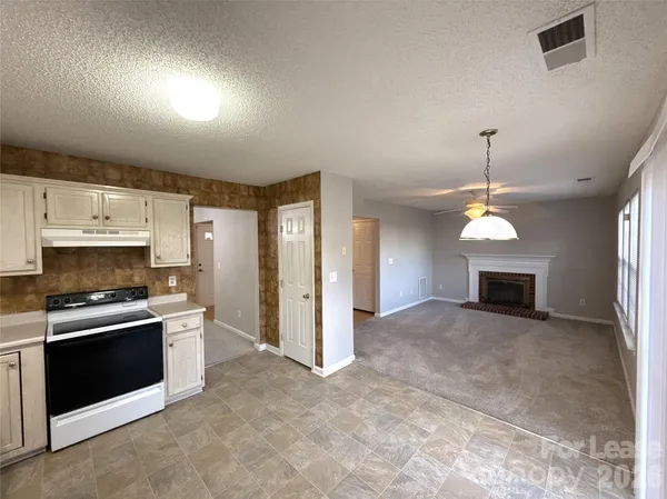 a view of a kitchen with a sink and a fireplace