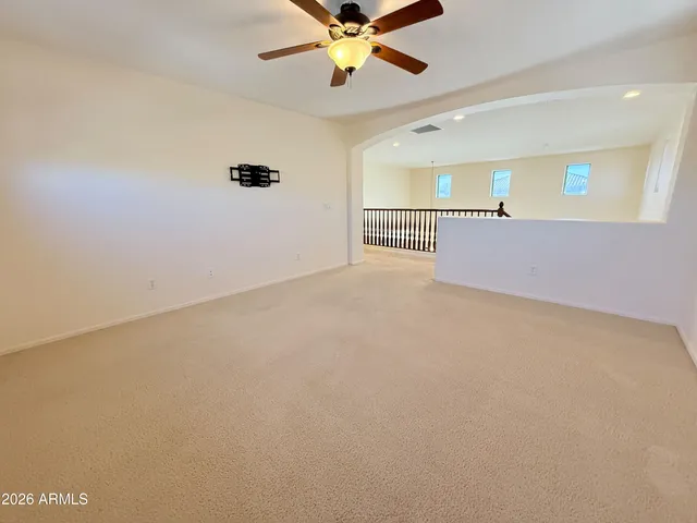 a view of a ceiling fan and window
