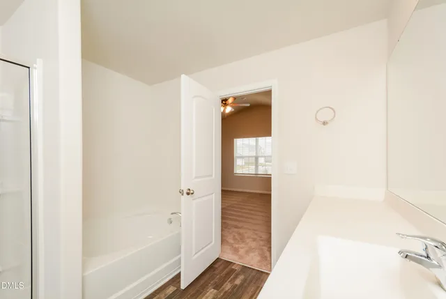a bathroom with a shower and a door