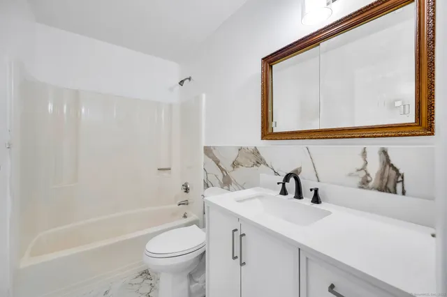 a bathroom with a sink a toilet and a bathtub