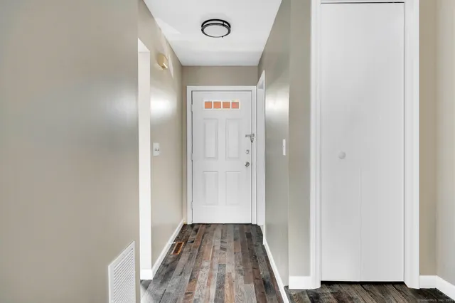 a view of hallway with wooden floor