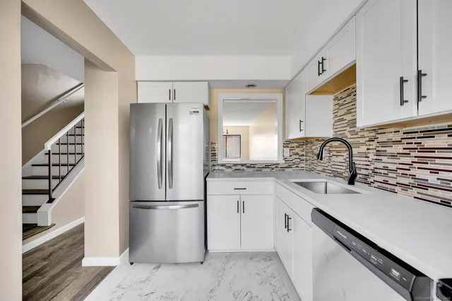 a kitchen with a refrigerator and a sink