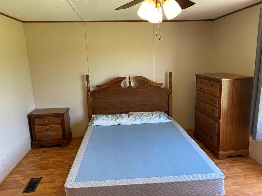 313 Lonesome Pine Road Bybee, TN 37713 - Photo 25 of 48 a room with a bed and a chandelier