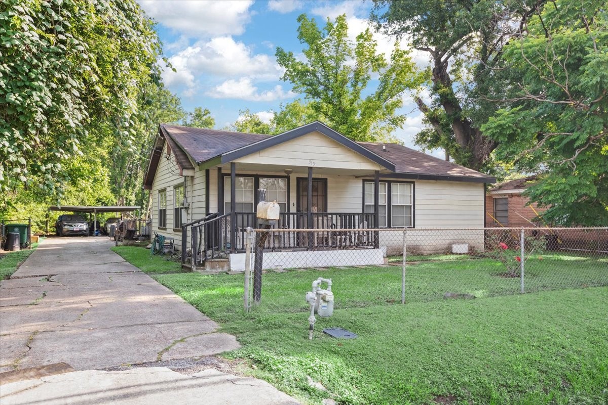 315 East Whitney Street Houston, TX 77022 - Photo 30 of 37 a front view of a house with a yard and trees