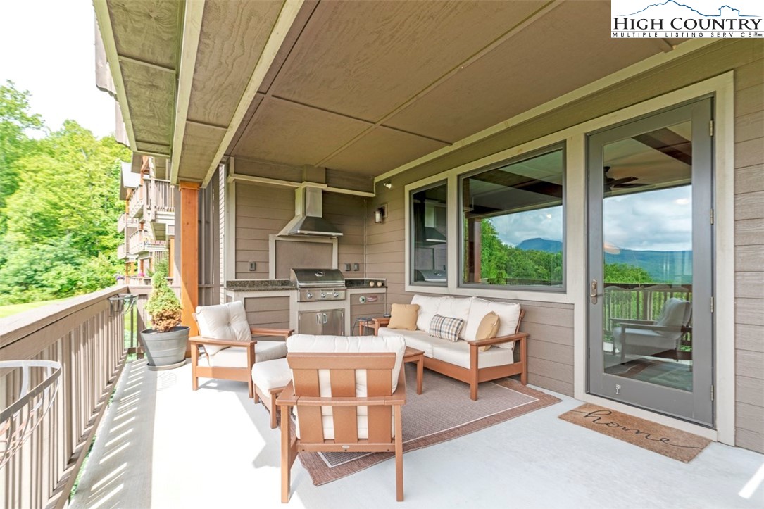 171 Falcon Trace, Unit C411 Boone, NC 28607 - Photo 15 of 46 a outdoor space with patio the couches and a dining table with the view of the balcony