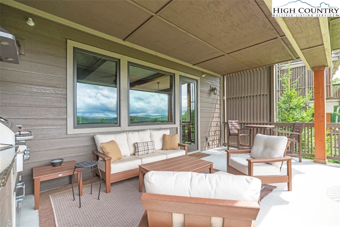 171 Falcon Trace, Unit C411 Boone, NC 28607 - Photo 16 of 46 a outdoor space with patio the couches and a dining table with the balcony