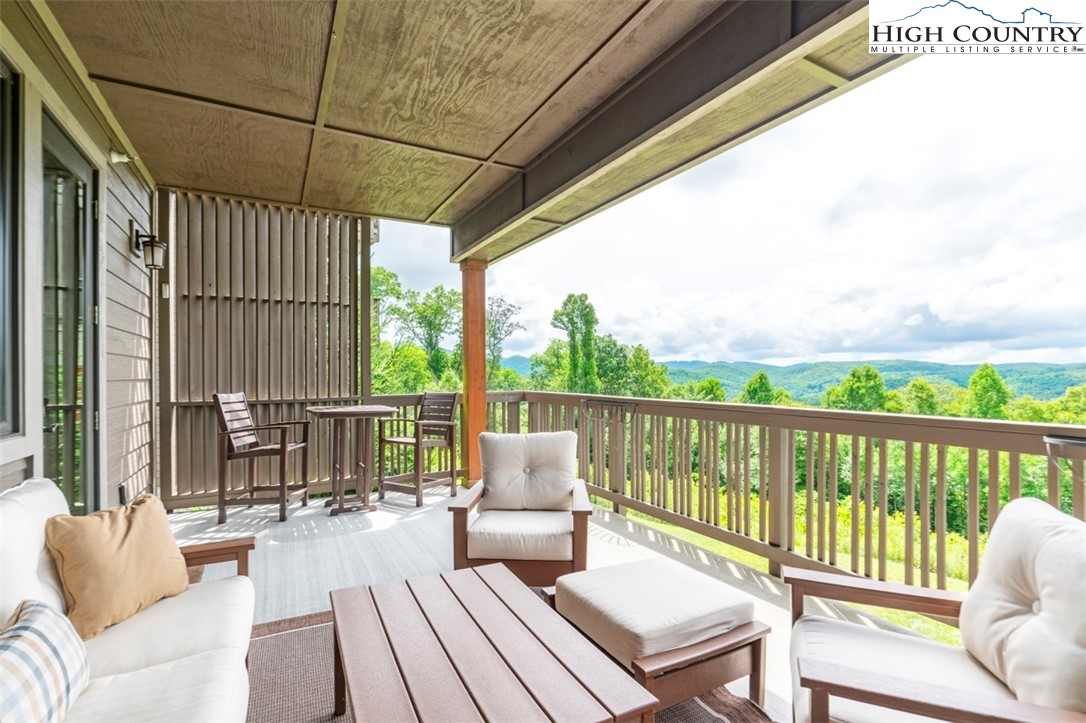 171 Falcon Trace, Unit C411 Boone, NC 28607 - Photo 17 of 46 a balcony with wooden floor table and chairs