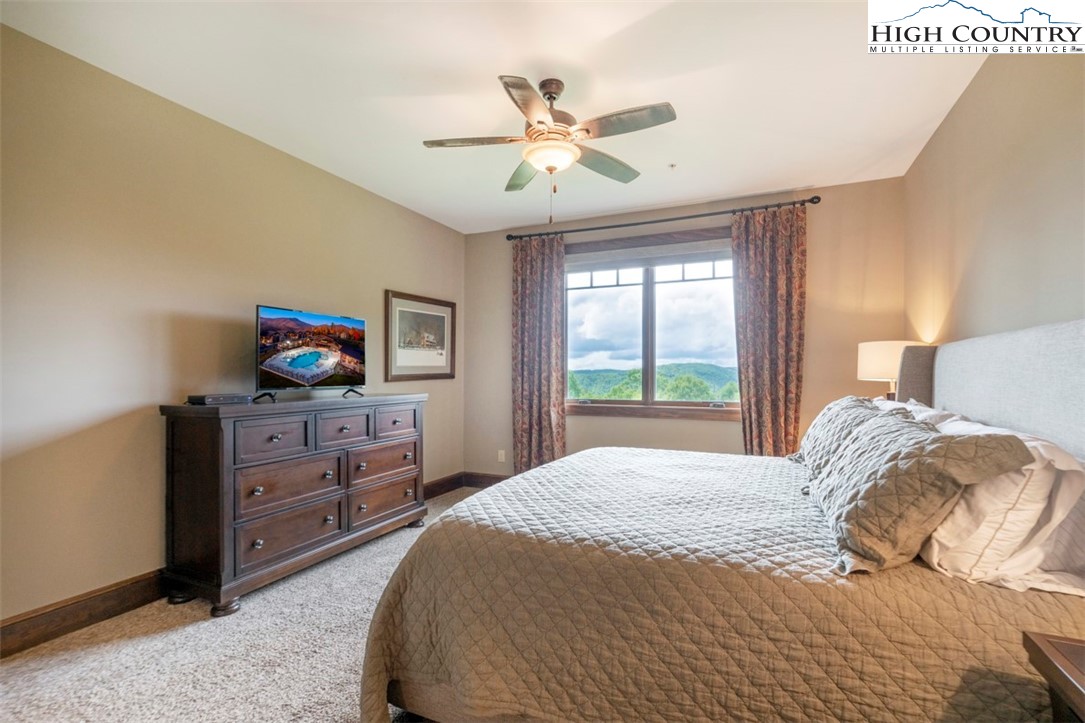 171 Falcon Trace, Unit C411 Boone, NC 28607 - Photo 25 of 46 a bedroom with a bed and a dresser