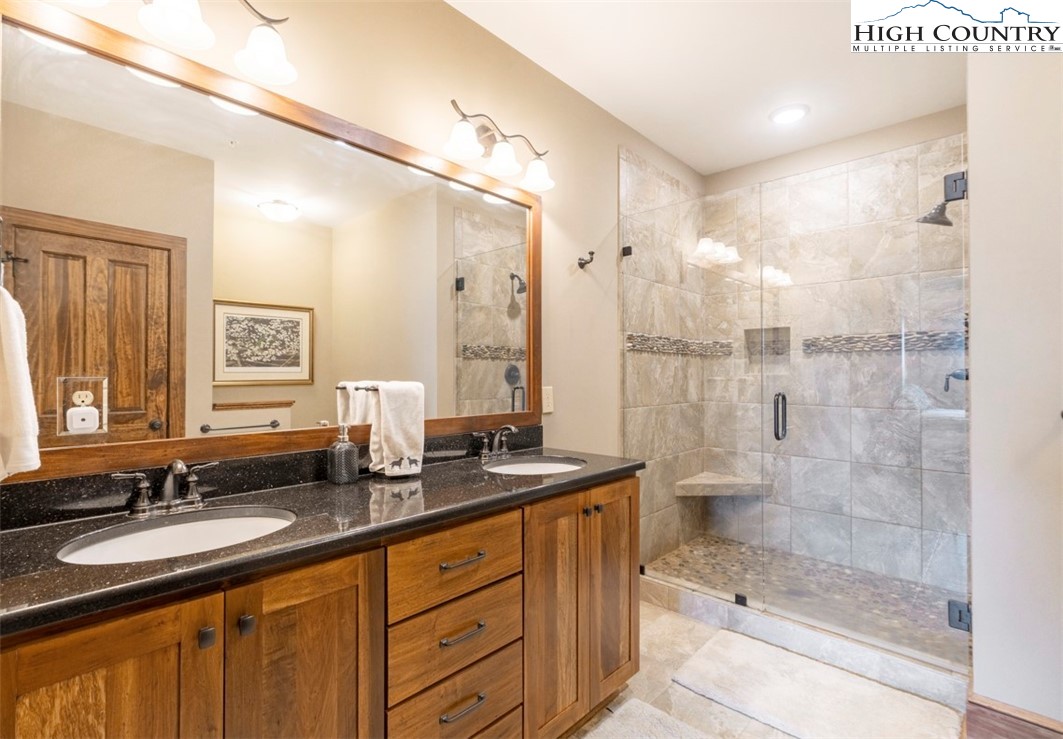 171 Falcon Trace, Unit C411 Boone, NC 28607 - Photo 28 of 46 a bathroom with a granite countertop sink mirror and shower