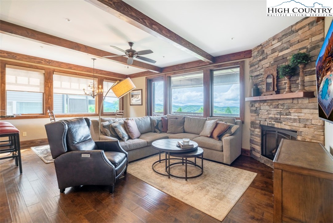 171 Falcon Trace, Unit C411 Boone, NC 28607 - Photo 3 of 46 a living room with furniture a fireplace and a large window