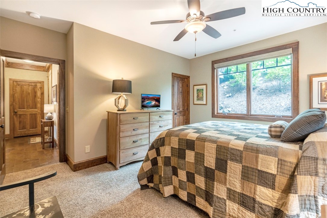 171 Falcon Trace, Unit C411 Boone, NC 28607 - Photo 31 of 46 a bedroom with a bed and a chandelier