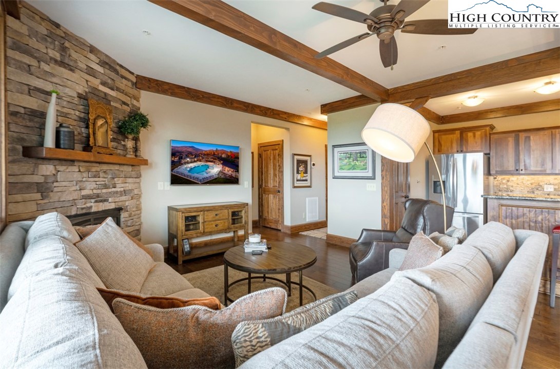 171 Falcon Trace, Unit C411 Boone, NC 28607 - Photo 4 of 46 a living room with furniture a ceiling fan and a fireplace