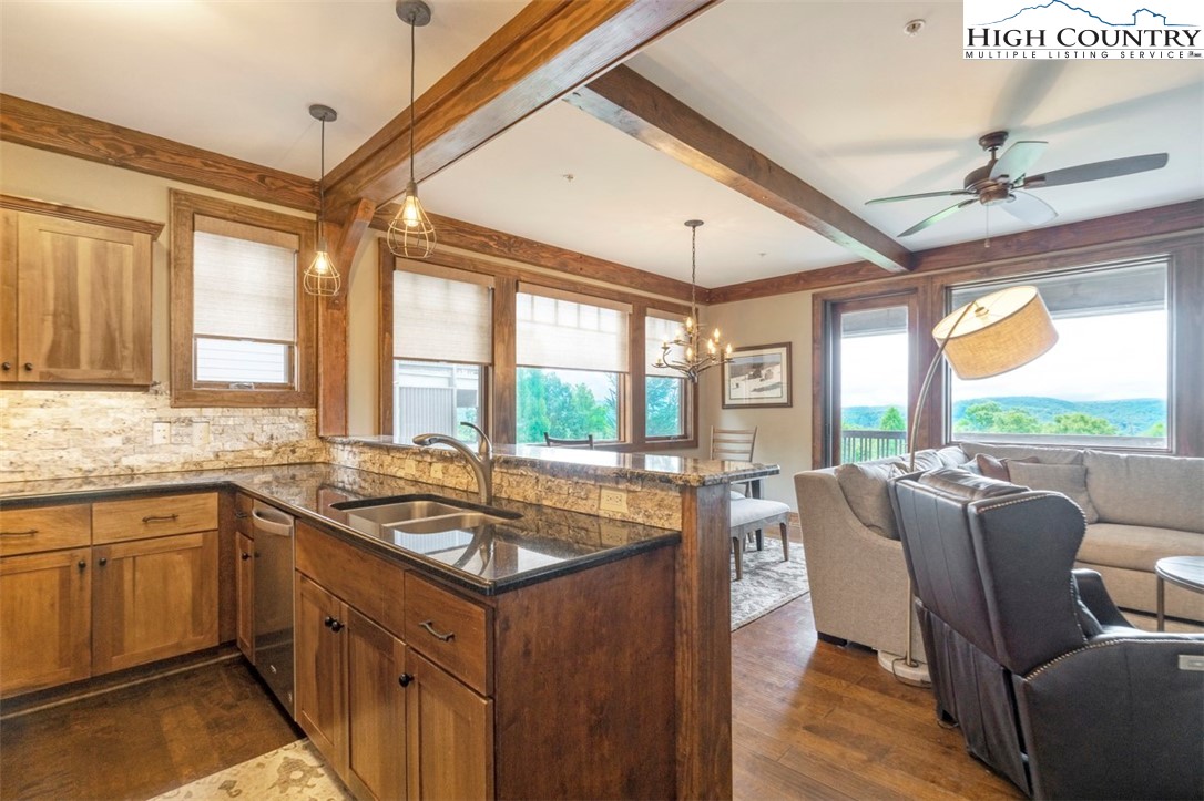 171 Falcon Trace, Unit C411 Boone, NC 28607 - Photo 7 of 46 a kitchen with stainless steel appliances granite countertop a sink stove and cabinets