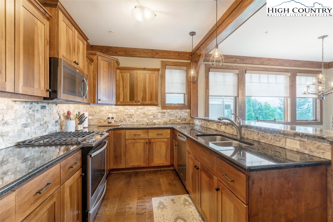 171 Falcon Trace, Unit C411 Boone, NC 28607 - Photo 8 of 46 a kitchen with stainless steel appliances granite countertop a sink stove and cabinets