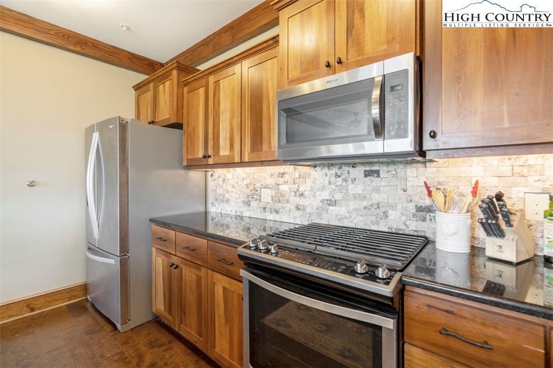 171 Falcon Trace, Unit C411 Boone, NC 28607 - Photo 10 of 46 a kitchen with stainless steel appliances granite countertop a refrigerator and a stove