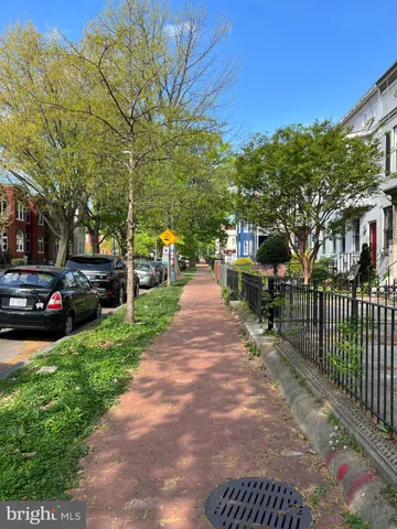 a view of a street with cars parked