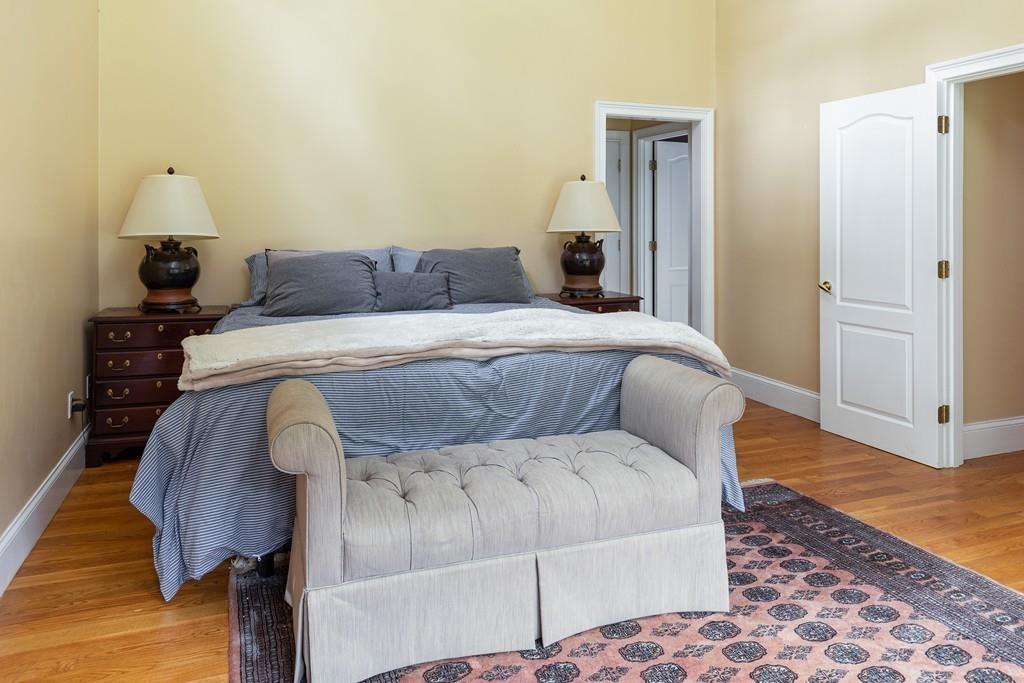77 Hiller Road Rochester, MA 02770 - Photo 18 of 33 a spacious bedroom with a bed and wooden floor