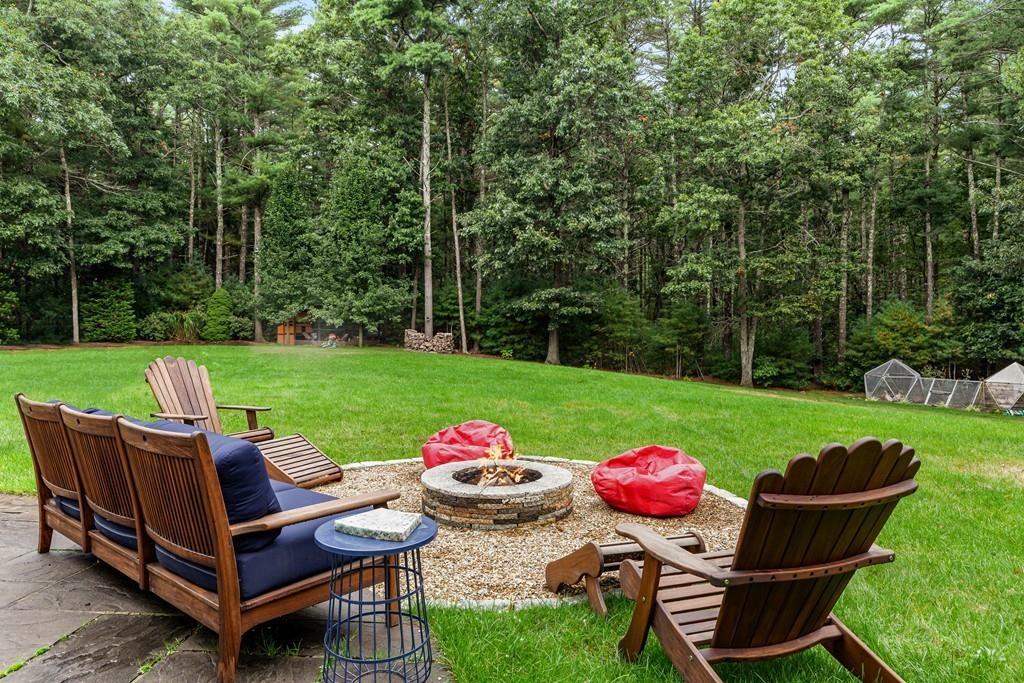 77 Hiller Road Rochester, MA 02770 - Photo 32 of 33 a view of a backyard with a table and a chairs