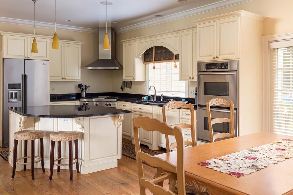 77 Hiller Road Rochester, MA 02770 - Photo 5 of 33 a kitchen with granite countertop a stove a sink and a refrigerator