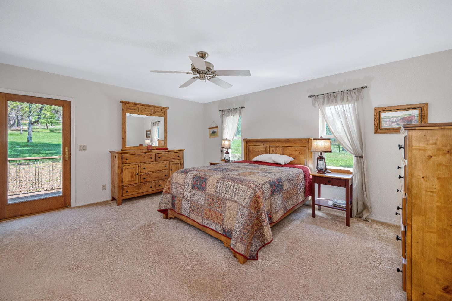 5215 Faraway Road Greenwood, CA 95635 - Photo 18 of 46 bedroom with access to exterior, light colored carpet, and ceiling fan