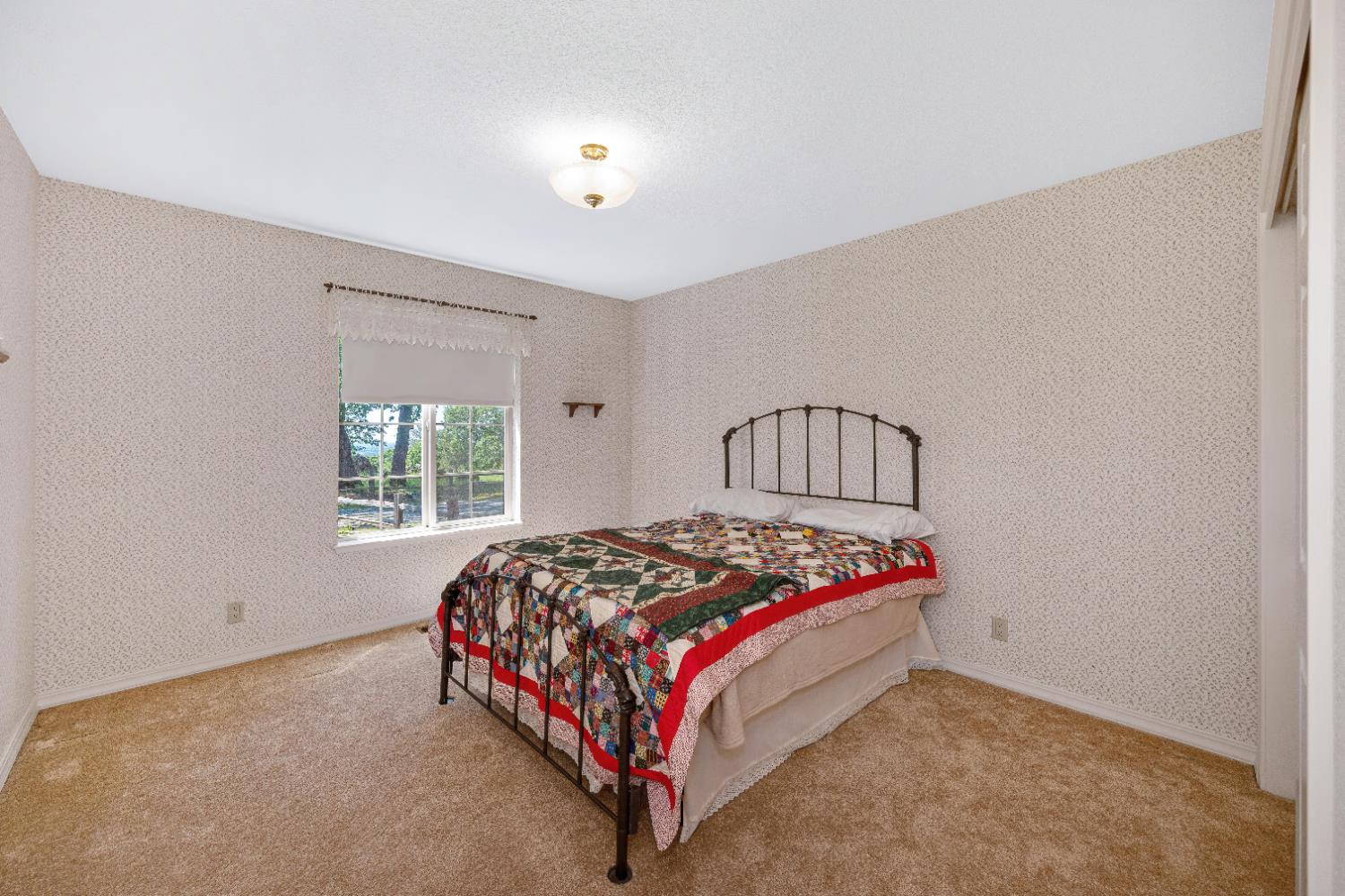 5215 Faraway Road Greenwood, CA 95635 - Photo 20 of 46 bedroom with wallpapered walls and light colored carpet