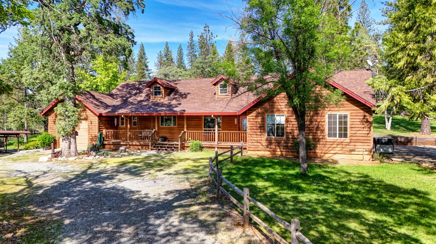 5215 Faraway Road Greenwood, CA 95635 - Photo 2 of 46 log-style house with a porch and a front lawn