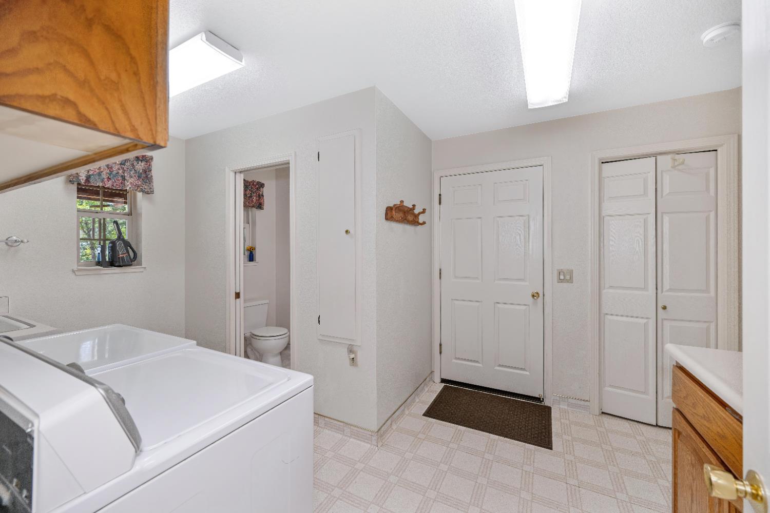 5215 Faraway Road Greenwood, CA 95635 - Photo 23 of 46 laundry area featuring light floors and a textured ceiling