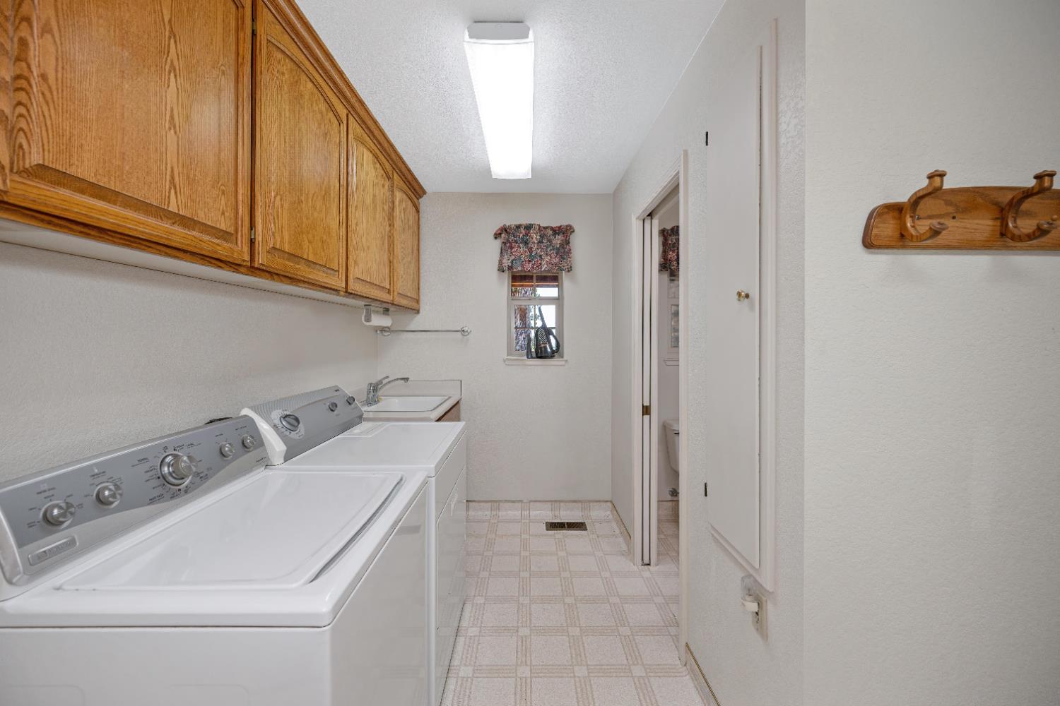 5215 Faraway Road Greenwood, CA 95635 - Photo 24 of 46 laundry area featuring light floors, a textured ceiling, independent washer and dryer, and cabinet space