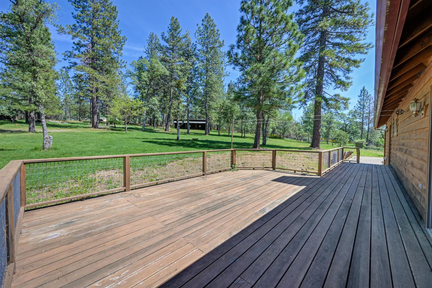 5215 Faraway Road Greenwood, CA 95635 - Photo 45 of 46 wooden terrace featuring a lawn and view of scattered trees