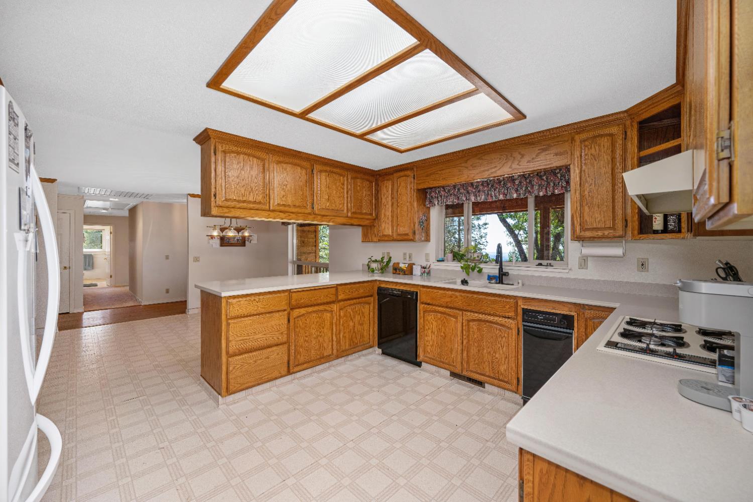 5215 Faraway Road Greenwood, CA 95635 - Photo 8 of 46 kitchen with light floors, light countertops, wood finish cabinetry, and a peninsula