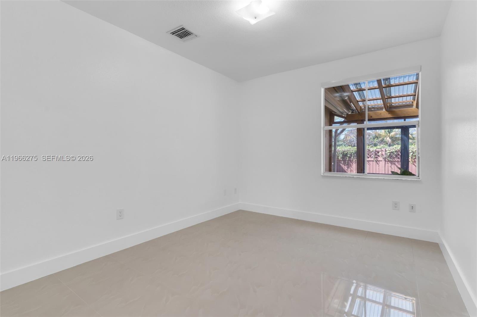 30 Southeast 6th Road Homestead, FL 33030 - Photo 12 of 34 an empty room with windows