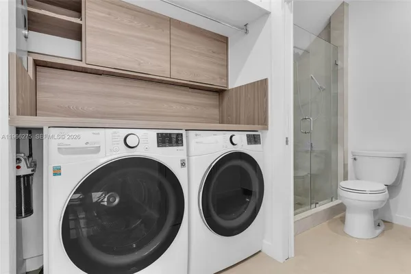a close view of a utility room with dryer and washer