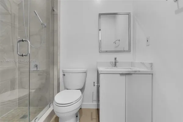 a bathroom with a toilet sink and shower