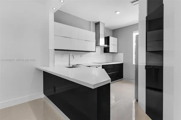 a kitchen with a sink a stove and refrigerator